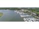 Picturesque aerial view of a waterfront marina filled with boats, set against a backdrop of lush trees and clear skies at 1880 Andell Bluff Blvd # Slip E 9, Johns Island, SC 29455