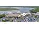 Aerial view showcasing a busy parking lot near waterfront establishments and a marina filled with various boats at 1880 Andell Bluff Blvd # Slip E 9, Johns Island, SC 29455