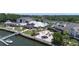 Aerial shot of a waterfront venue featuring multiple buildings, outdoor dining, and a picturesque pier with boats docked nearby at 1880 Andell Bluff Blvd # Slip E 9, Johns Island, SC 29455