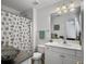 Clean, well-lit bathroom with white cabinetry, shell themed shower curtain, and a decorative bowl at 1921 Old Parsonage Rd, Charleston, SC 29414