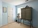 Bedroom with blue walls, neutral carpet, and a decorative cabinet and side table at 1921 Old Parsonage Rd, Charleston, SC 29414
