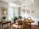 Cozy dining room with hardwood floors, chandelier, and natural lighting at 1921 Old Parsonage Rd, Charleston, SC 29414