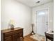 Bright entryway with hardwood floors, white door and trim, and stylish furnishings at 1921 Old Parsonage Rd, Charleston, SC 29414
