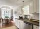 Kitchen view, looking towards the dining room with chandelier and natural light at 1921 Old Parsonage Rd, Charleston, SC 29414
