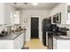 Well-maintained kitchen with white cabinets, stainless steel appliances and a door leading to the garage at 1921 Old Parsonage Rd, Charleston, SC 29414
