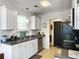 This kitchen features white cabinets, gray countertops, and stainless steel appliances at 1921 Old Parsonage Rd, Charleston, SC 29414