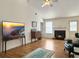 Living room with fireplace, hardwood floors, and a modern television with a landscape image at 1921 Old Parsonage Rd, Charleston, SC 29414