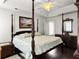 Spacious main bedroom with trey ceilings, four poster bed, and lots of natural light at 1921 Old Parsonage Rd, Charleston, SC 29414