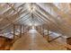 Long view of attic with wooden beams, flooring, lighting and insulation at 200 Broughton Rd, Moncks Corner, SC 29461