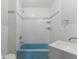 Bright bathroom featuring blue bathtub, white tiled walls with accent strip and chrome fixtures at 200 Broughton Rd, Moncks Corner, SC 29461