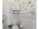 Cozy bathroom with toilet, white wall cabinet, and patterned wallpaper at 200 Broughton Rd, Moncks Corner, SC 29461