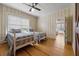 Bright bedroom with hardwood floors, two twin beds, wallpapered walls, and a ceiling fan at 200 Broughton Rd, Moncks Corner, SC 29461