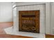Intricate metalwork detailing on a fireplace featuring a white tile surround at 200 Broughton Rd, Moncks Corner, SC 29461