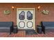 Elegant front door with decorative glass, flanking benches, and decorative sconces at 200 Broughton Rd, Moncks Corner, SC 29461