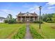 Traditional home boasts a well-kept lawn, covered front porch, and welcoming curb appeal at 200 Broughton Rd, Moncks Corner, SC 29461