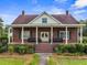 Charming brick home featuring a covered porch, manicured lawn, and classic architectural details at 200 Broughton Rd, Moncks Corner, SC 29461