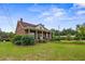 Well-maintained home features a spacious lawn, charming front porch, and mature trees at 200 Broughton Rd, Moncks Corner, SC 29461