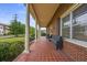 Extended covered porch features classic details, brick flooring, and welcoming seating at 200 Broughton Rd, Moncks Corner, SC 29461