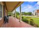 Inviting porch view with brick flooring, seating, and architectural columns at 200 Broughton Rd, Moncks Corner, SC 29461