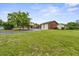 Expansive front yard featuring mature trees and a circular driveway leading to the residence and detached garage at 200 Broughton Rd, Moncks Corner, SC 29461