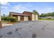 View of the three-car detached garage, showcasing solar panels and ample parking space at 200 Broughton Rd, Moncks Corner, SC 29461