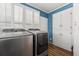 Laundry room with new appliances, white cabinets, and a bead board accent wall at 200 Broughton Rd, Moncks Corner, SC 29461