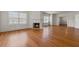 Open living room with glowing fireplace, hardwood floors and natural light at 200 Broughton Rd, Moncks Corner, SC 29461