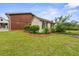 A small shed is set close to a house and features decorative landscaping and windows with shutters at 200 Broughton Rd, Moncks Corner, SC 29461