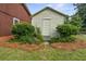 Exterior shot of a small shed surrounded by landscaping and mulch against the backdrop of the main home at 200 Broughton Rd, Moncks Corner, SC 29461