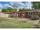 A spacious backyard is complete with a picnic table, brick exterior, grassy area, and wooden fence at 201 Judith Dr, Summerville, SC 29485