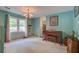 Bright dining room with vintage-style chandelier, piano, and natural light streaming through the window at 201 Judith Dr, Summerville, SC 29485