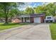 Single story brick home with a well maintained lawn, a trailer parked in the driveway at 201 Judith Dr, Summerville, SC 29485