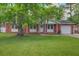 Charming brick home featuring a well-manicured lawn and mature tree with spanish moss at 201 Judith Dr, Summerville, SC 29485
