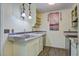 A quaint kitchen is complete with a granite countertop, stainless steel dishwasher, and painted wooden panel walls at 201 Judith Dr, Summerville, SC 29485