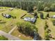 Spacious property featuring a fenced pool, sheds, outbuildings, wooded acreage and long driveway at 208 Mini Farm Rd, Bonneau, SC 29431