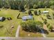 Expansive aerial view of property featuring a pool, large yard, outbuildings, and wooded acreage at 208 Mini Farm Rd, Bonneau, SC 29431