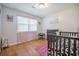 Bedroom with dark wood trim crib, natural light, and laminate flooring at 208 Mini Farm Rd, Bonneau, SC 29431