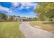 View of home with long gravel driveway and oversized two car garage at 208 Mini Farm Rd, Bonneau, SC 29431