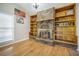 Bright room with a brick fireplace, built-in shelving, and lots of natural light at 208 Mini Farm Rd, Bonneau, SC 29431