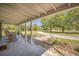 Inviting front porch with rocking chairs and views of the landscaped yard at 208 Mini Farm Rd, Bonneau, SC 29431