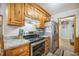 Open kitchen showcasing stainless steel range, granite countertops, and wooden cabinets at 208 Mini Farm Rd, Bonneau, SC 29431