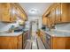 Galley kitchen featuring stainless steel appliances, granite countertops, and custom cabinets at 208 Mini Farm Rd, Bonneau, SC 29431