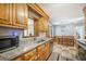 Kitchen sink and granite counters visible from adjacent dining room with wood accents at 208 Mini Farm Rd, Bonneau, SC 29431