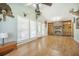 Open living room with a fireplace, built-in shelves, lots of windows, and wood flooring at 208 Mini Farm Rd, Bonneau, SC 29431