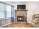 Cozy living room showcasing a brick fireplace with a wooden mantel and a wall-mounted television at 208 Mini Farm Rd, Bonneau, SC 29431