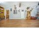 Open living room with wood flooring, built-in shelving, and unique wall decor at 208 Mini Farm Rd, Bonneau, SC 29431
