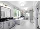 Bright, spacious bathroom with a soaking tub, walk-in shower with patterned tile, and dual vanities at 208 Quimby Hill Dr, Huger, SC 29450