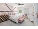 Charming bedroom featuring soft pink accents, natural light, and decorative details that create a soothing retreat at 208 Quimby Hill Dr, Huger, SC 29450