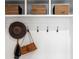 Charming entryway featuring hooks for coats, built-in cubbies, a wooden bench and stylish decor at 208 Quimby Hill Dr, Huger, SC 29450
