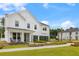 Stunning two-story home with white siding, black trim, inviting entry, beautiful landscaping and a paver sidewalk at 208 Quimby Hill Dr, Huger, SC 29450